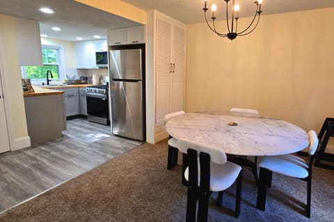 Bright dining area with modern kitchen and stylish seating