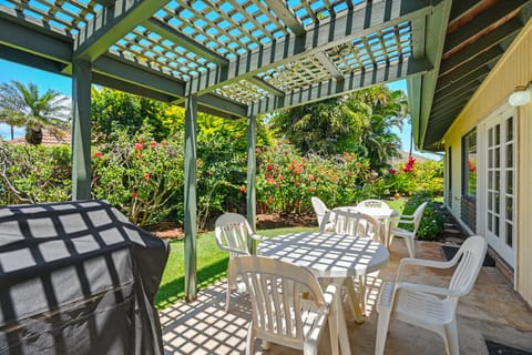 Step outside to your private patio, where dappled sunlight filters through the pergola onto comfortable seating. The lush tropical garden creates a serene backdrop for your morning coffee or evening relaxation.