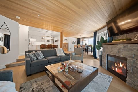 Spacious open-concept living area with a cozy gas fireplace, AC and plenty of room to relax.