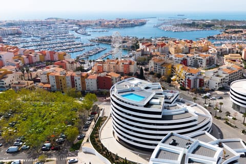 Cap d'Agde's marina from above — boats, a Ferris wheel, and the Languedoc coastline right on your doorstep.