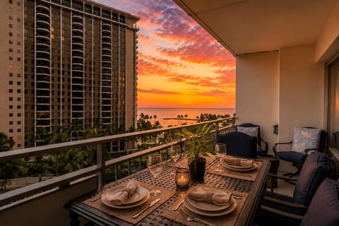 Private lanai with panoramic sunset views overlooking the marina, city skyline, and Pacific Ocean.