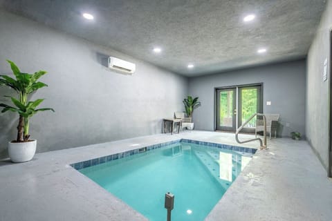 Step into your private indoor pool sanctuary, where natural light streams through glass doors and lush greenery creates a serene escape for relaxation and rejuvenation.