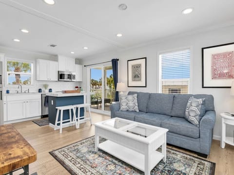 Gather with family and friends in this warm, inviting living space featuring comfortable seating, a fully equipped kitchen, and plenty of natural light. It`s the perfect place to unwind after a day at the beach.