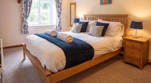 Comfortable king-size bedroom with quality linens, soft towels and peaceful countryside views.