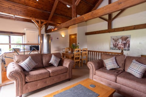 Open-Plan Living Under Vaulted Beams - The Wheel House's stunning A-frame ceiling and exposed timber trusses set the scene for this uniquely designed mill cottage, perfect for groups who want something genuinely one-of-a-kind