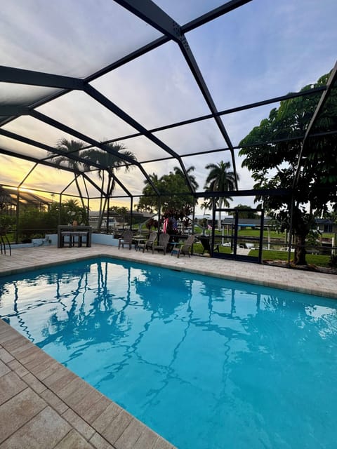Screened private pool with tropical views and relaxing outdoor seating