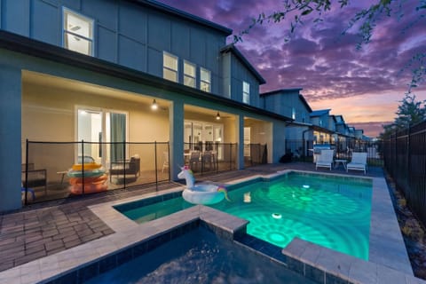 Private pool and spa with covered patio at a beautifully lit modern home
