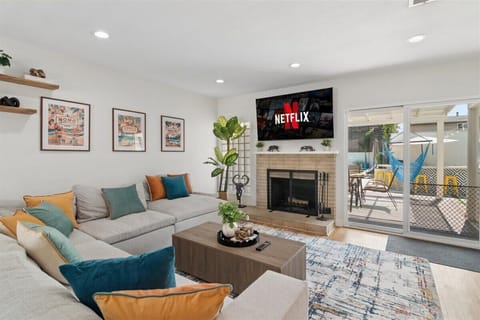 Beautiful sun-soaked living room with huge TV, very comfortable seating for the whole group, and wood-burning fireplace if ever needed on a cool night.