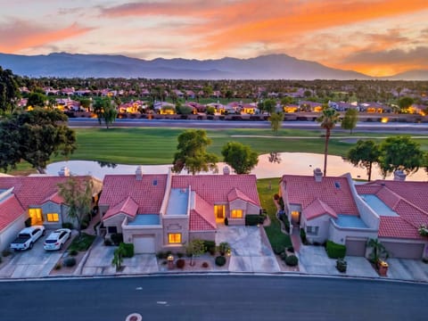 Breathtaking twilight aerial view showcasing the property's prime location right along the pristine golf course and water features.