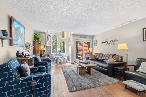 Sink into comfortable seating where natural light pours through large windows, perfect for your morning coffee or evening relaxation in this thoughtfully designed living space.