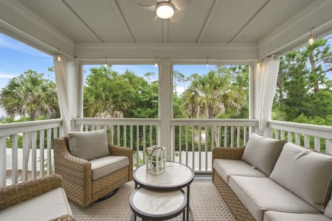Turtles Nest- Sink into plush cushioned seating on your private screened porch, where lush palms frame your peaceful treetop retreat and coastal breezes drift through.