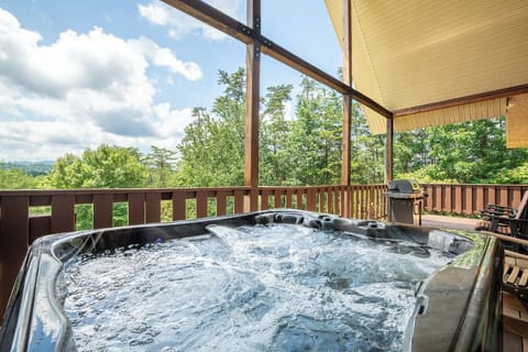 Soak in your private hot tub as you gaze out at lush forest views and rolling mountains. Warm bubbles, fresh air, and a stunning natural backdrop await your relaxation.