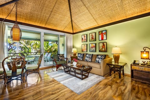 Sink into the plush sofa beneath a stunning woven bamboo ceiling and let the tropical breeze from your private balcony wash over you. Your island escape awaits.