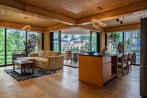 Wide open kitchen and living room, all wood and light