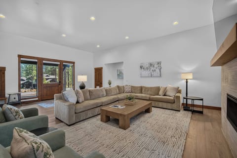Sink into plush seating and let the day's adventures settle around you. Natural light pours through tall windows, warming the wood tones and inviting you to unwind in your spacious mountain retreat.