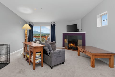 Unwind in your spacious living room with cozy fireplace, mountain views, and all the comforts of home—perfect for relaxing after a day of adventure.