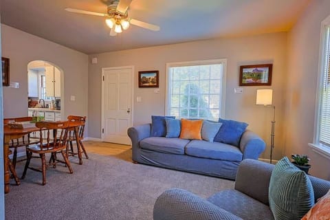 Bright living room with comfy seating, dining table, and soft natural light for relaxing or working
