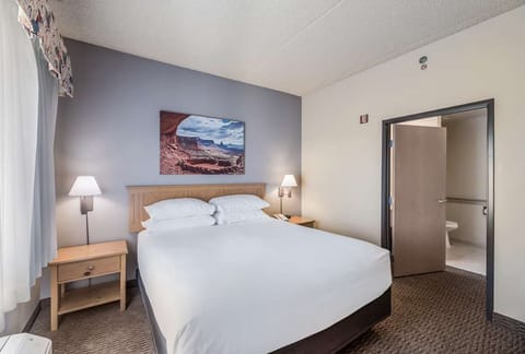 Drift off in a calm king room with soft lighting.