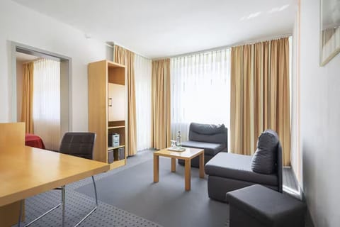 Unwind on the sofa as daylight pours through tall curtains.