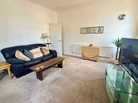 Comfortable and spacious living area with cosy seating, Smart TV, and plenty of natural light – the perfect place to relax after a day exploring Birmingham or working locally