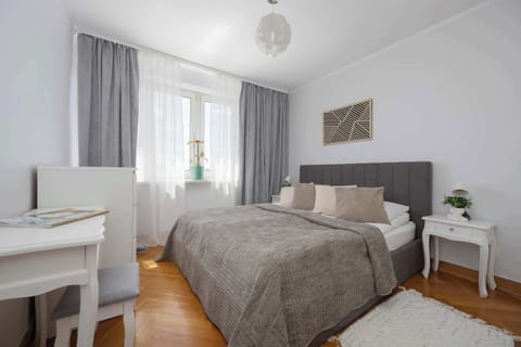 A cozy bedroom with a large double bed and elegant furnishings. Soft colors create a peaceful atmosphere for a restful night's sleep.