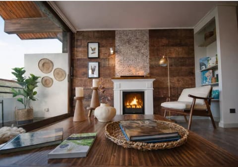 Relax by the fireplace in a cozy living room with warm décor.