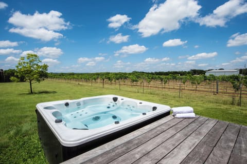 Bask in bubbling bliss with vineyard views in the private hot tub​