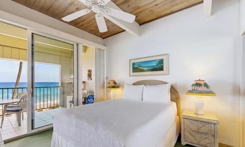 Bright Primary Bedroom with Vaulted Ceilings, Ocean Views, and Direct Balcony Access