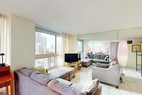 Comfortable living area with city views beyond the windows