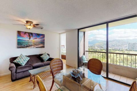 Sunlit living room and dining space with balcony views