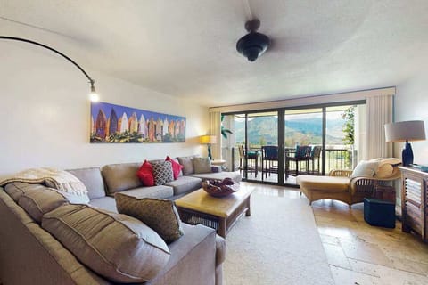 Entertainment corner pairs television timber cabinetry and cheerful accent cushions