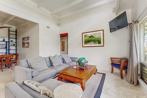 Bright Open-Concept Living Area with High Vaulted Ceilings & Wall TV
