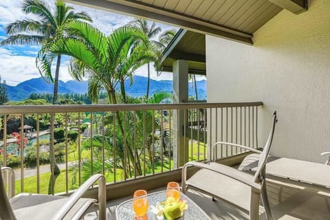 Covered balcony provides seating, mountain views, and refreshing tropical scenery
