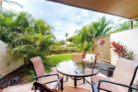 Covered patio seating overlooks tropical greenery for relaxed island mornings