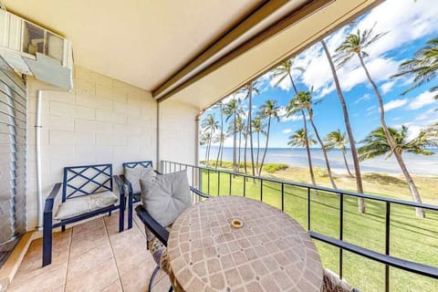 Private lanai with tropical views of palm trees swaying in the breeze.