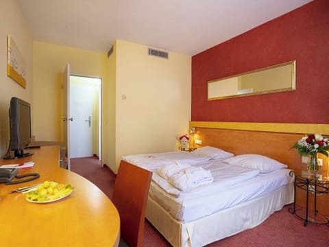Relax after exploring in a spacious room with warm tones.