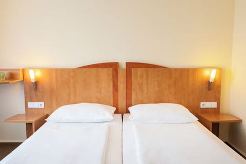 Drift off comfortably with supportive pillows and bedside lights.