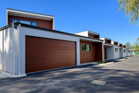 Modern townhomes with private garages on a quiet, clean lane