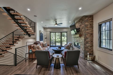 Spacious living room with fireplace, smart TV, and walkout patio