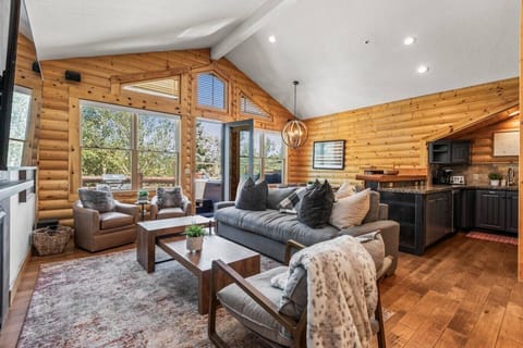 Open-concept family room with high ceilings, cozy seating, and stunning views of Snow Park Lodge and Deer Valley Main Base. The perfect place to gather, unwind, and watch the mountain come alive.