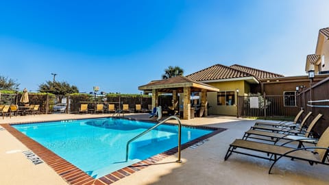 Take a dip in the outdoor pool lined with sun loungers and shaded seating