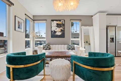 Light-filled living with direct Hollywood Sign views from the private balcony