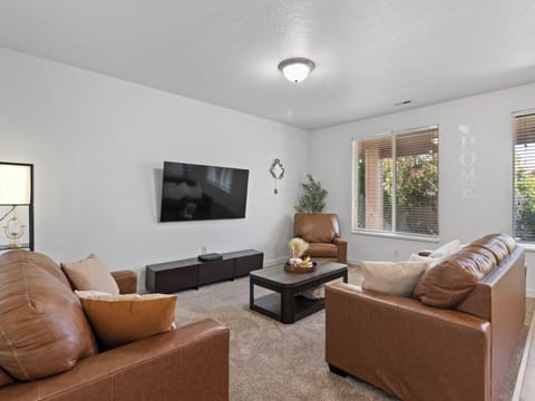 Comfortable lounge with quality seating, entertainment center, and natural light. Your group's main gathering spot.