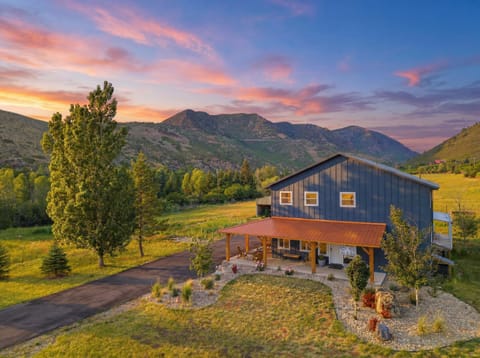 Aerial view reveals the stunning mountain valley setting surrounding this modern family home.