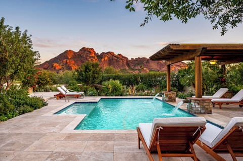 Dusk swims beneath a mountain lit up in fire.