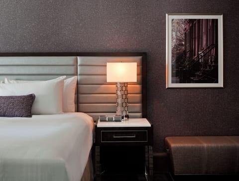 Settle in with warm bedside lighting and curated artwork.