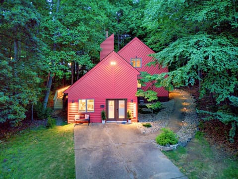Charming woodland retreat with bold architecture and inviting evening glow