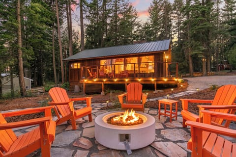 Cozy forest cabin with fire pit patio and glowing sunset ambiance