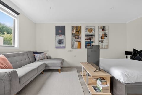 Sunny studio with chaise sofa, queen bed, and smart TV