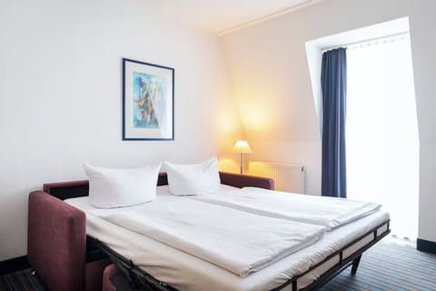 Lounge comfortably on the sofa bed beside soft, warm lighting.